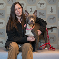 Courtney Gustafson sits with her dog.