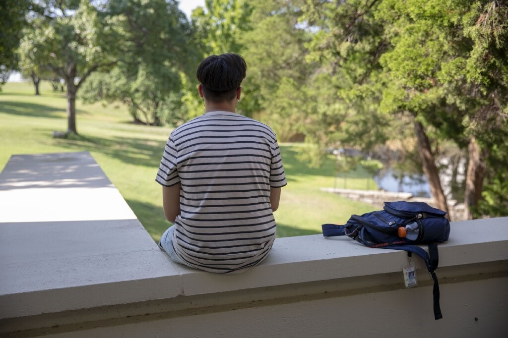 Student looking out at campus landscape
