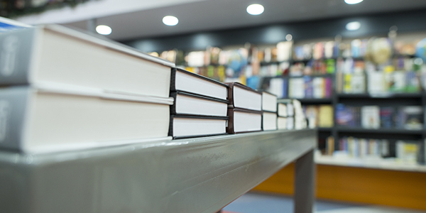 A stack of books on a table in a store.