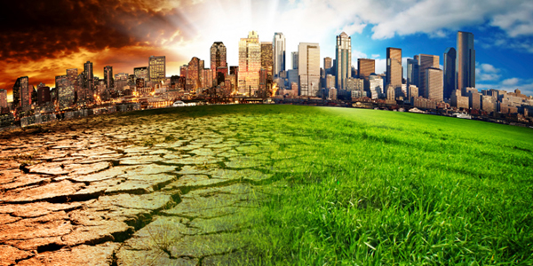 Ground that turns into green grass with a large city in the background.