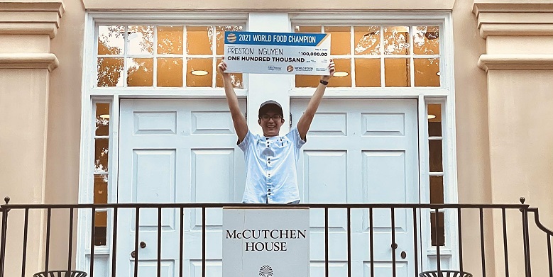 Preston Nguyen hold $100,000 check from World Food Championship.