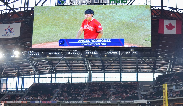 Dallas Mavericks draft pick Dereck Lively II, throws out the ceremonial  first pitch before a baseball game between the Los Angeles Angels and Texas  Rangers, Monday, Aug. 14, 2023, in Arlington, Texas. (